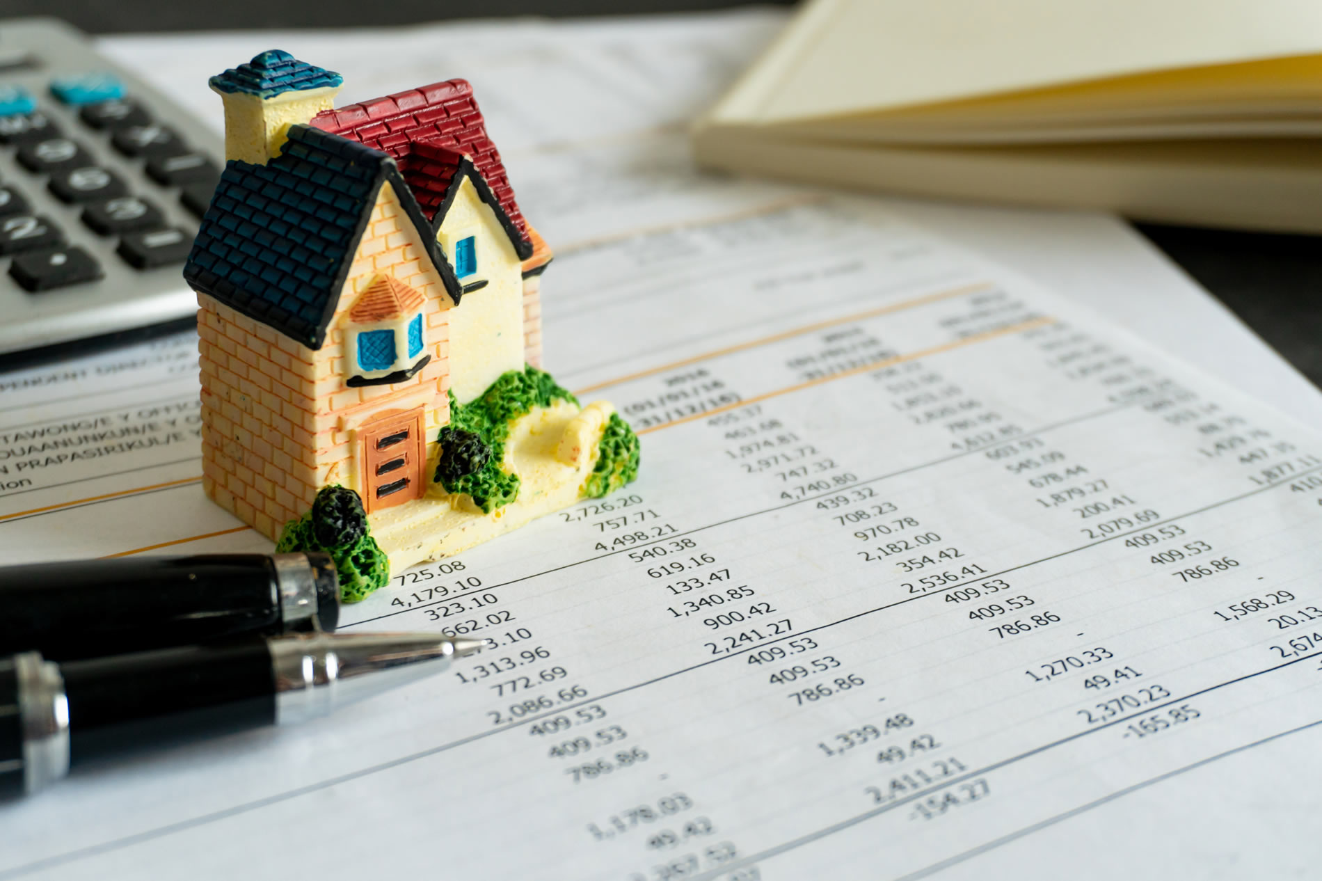 Home loan bank debit statement with house miniature Home loan bank debit statement with house miniature